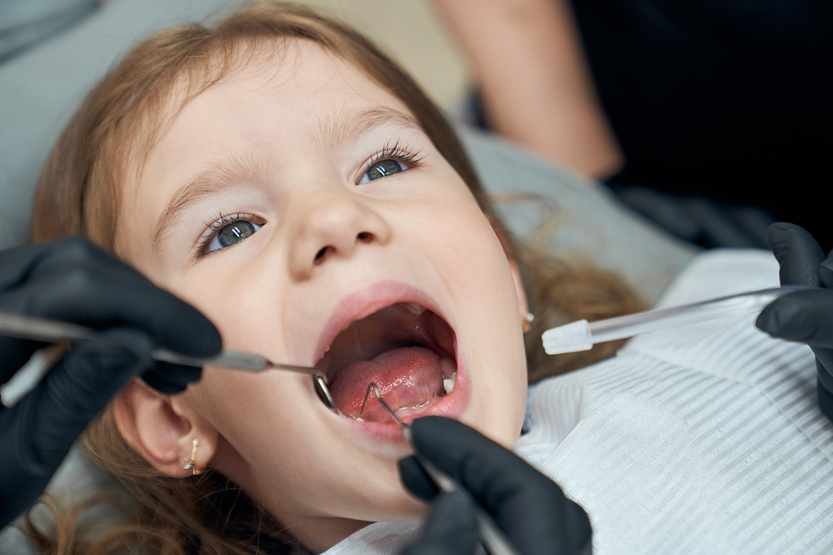 Dentist examining condition teeth little patient